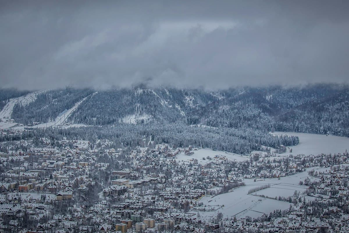 Bakuriani resort village nestled below snowy forested mountains